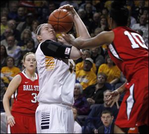 UT's Kyle Baumgartner gets the ball smacked against her face on a foul by Ball State's Shanee' Jackson tonight at Savage Arena in Toledo.