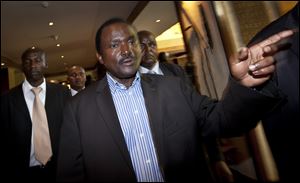 Kalonzo Musyoka, center, Kenya's current Vice President and running mate of presidential candidate Raila Odinga, gestures as he leaves after speaking at a news conference in Nairobi. The coalition of Kenya's prime minister Raila Odinga says the vote tallying process now under way to determine the winner of the country's presidential election 