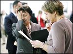  Ann Oganesian, left, of Newton, Mass., speaks with a State Department employee about job opportunities during a job fair in Boston. U.S. employers ramped up hiring in February, adding 236,000 jobs.