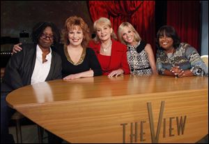 From left, Whoopi Goldberg, Joy Behar, Barbara Walters, Elizabeth Hasselbeck and Sherri Shepherd pose on the set of their daytime talk show, 