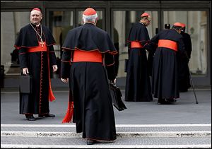 Cardinal Gianfranco Ravasi, left, joins other cardinals as he arrives at the Vatican. The cardinals plan to keep meeting before the start of Tuesday’s papal conclave. 