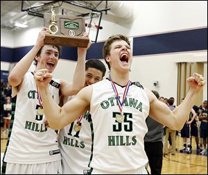 Ottawa Hills' Geoff Beans, left, A.J. King, and Lucas Janowicz celebrate after defeating Toledo Christian. The Green Bears will face Colonel Crawford in a Division IV regional semifinal.