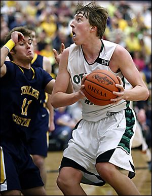 R.J. Coil, who had 27 points for Ottawa Hills, drives against Toledo Christian's Ben Ivan.