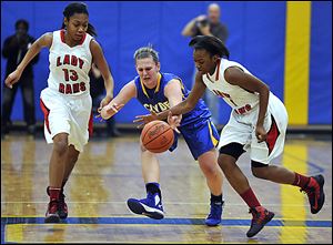 Rogers' Sasha Dailey, right, executes a steal from Clyde's Amanda Cahill as Rams  teammate Toriana Easley follows the action Friday night at Ontario High School in a regional final game.