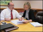  Chuck Mira and Connie Farell look over paperwork at the office of Mira & Kolena on Monroe Ave.