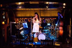 Nicole New, of Detroit, center, sings with the Scott Gwinell Trio on Friday evening. The restaurant features a jazz trio or a classical pianist five nights a week, and dancing as the night goes on.