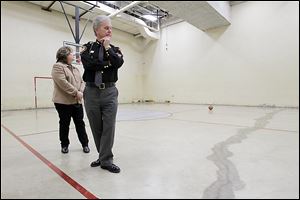 Lucas County Commissioner Carol Contrada and Sheriff John Tharp examine the damaged recreation area at the jail. A month ago, a rusty pipe burst in the ceiling of the gymnasium, spewing discarded food and other kitchen waste on the gym floor.