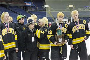 Northview senior Zander Pryor (19) and senior Drew Crandall, far right, accept their state runner-up trophy as they and their teammates line up after the Wildcats lost to Shaker Heights.