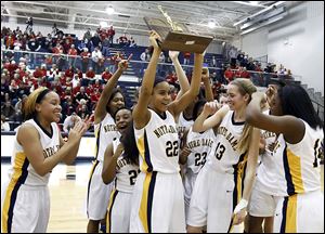 Notre Dame's Jayda Worthy lifts the trophy the Eagles received after winning the regional championship. Worthy had a big hand in the victory, sinking the clinching free throws in the final seconds.