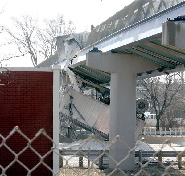 Dump truck's raised cab slams into Ohio pedestrian bridge; busy I90