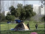  San Jose city workers Mark Ruffing, left, and Rita Tabaldo attach eviction notices to a tent at a tent city in San Jose. The Silicon Valley is adding jobs faster than it has in more than a decade as the tech industry roars back.But a more ominous record is also being set this year: food stamp participation just hit a 10 year high, African American wages fell 18 percent in two years and median incomes fell throughout the region. Simply put, while the ultra rich are getting even ultra richer, record numbers of Silicon Valley residents are slipping into poverty.