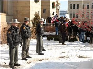 Jefferson Co. sheriff's deputies stand nearby during the  protest at the Jefferson County Courthouse in Steubenville, Ohio, on Jan. 5. Tensions within the town have not subsided with time.