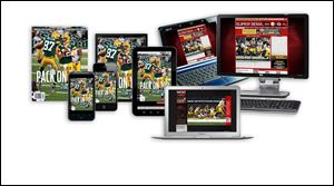 A copy of Sports Illustrated magazine, left, is shown as Sports Illustrated digital subscriptions are displayed on smartphones, tablets, laptops, and a desktop computer. Time Warner Inc. on said that it will spin off the magazine unit behind Time, Sports Illustrated, and People into a separate, publicly traded company by the end of the year.
