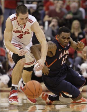 Ohio State's Aaron Craft, left, and Illinois' Tracy Abrams chase a loose ball during the second half Sunday in Columbus. Craft had 14 points and six assists for the Buckeyes in their win against Illinois. 