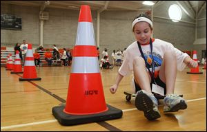 Mia McCartney of North Baltimore skirts a cone in the Scooter Slalom Saturday in the Wood County Youth Olympics at Bowling Green State University.