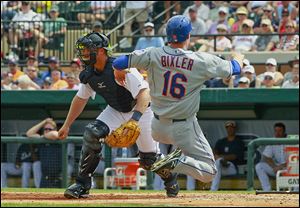 The Mets' Brian Bixler scores in the fifth inning before Tigers catcher Bryan Holaday can get the throw. Bixler also homered for New York.
