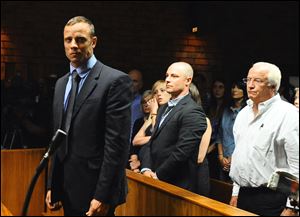 Olympian Oscar Pistorius stands following his bail hearing in Pretoria, South Africa, last month.