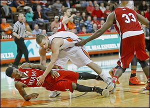 The game gets physical as Miami's Geovonie McKnight is knocked over by BG's Luke Kraus during second half of the first round of the MAC tournament at the Stroh Center on Monday.