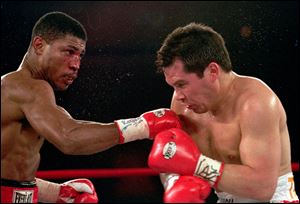 Tony Martin, left, of Philadelphia, punches Mexico's Julio Cesar Chavez in the second round of their Welterweight Special Attraction fight, in Las Vegas in March, 1997.