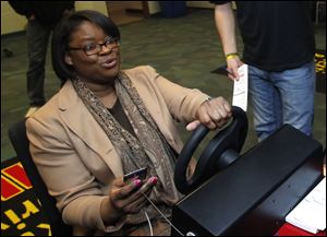 Owens student Kewanna Vessel reacts to hitting a U-Haul while texting and driving while using a simulator.