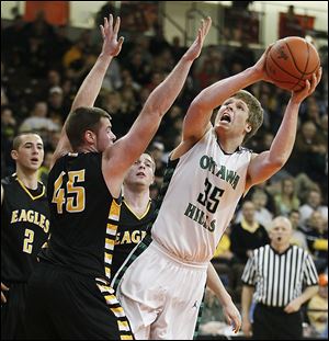 Ottawa Hills' Lucas Janowicz puts up a shot against Colonel Crawford's Clay Jury (45) during a Division IV regional semifinal at Bowling Green State University. Janowicz scored 10 points.