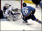  Greenville goalie Scott Stajcer deflects a shot by the Walleye's Stephon Thorne.