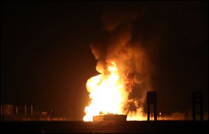 A tugboat and barge are engulfed in flames after hitting a natural gas pipeline in Bayou Perot about two miles south of lower Lafitte, Louisiana, Tuesday.
