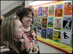  Brianna Kamelesky, 13, left, took a look at some of her fellow students' artwork with art teacher Jennifer Bucher right, during Wednesday evening's 3rd annual Spring Celebration of the Arts at Timberstone Jr. High School in Sylvania.