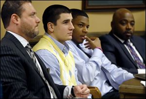 From left, Defense attorney Adam Nemann, his client, defendant Trent Mays, 17, defendant 16-year-old Ma'lik Richmond and his attorney, Walter Madison, listen to testimony during Mays and Richmond's trial on rape charges in juvenile court in Steubenville, Ohio.