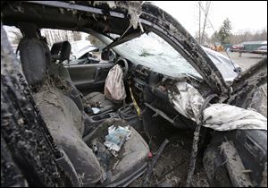 This Monday, March 11, 2013 photo in Southington, Ohio shows the interior of a vehicle where six people died in a crash early Sunday in Warren, Ohio. Two teens who escaped the crash that killed six friends in a swampy pond wriggled out of the wreckage by smashing a rear window and swimming away from the SUV, a state trooper said Monday. (AP Photo/Tony Dejak)