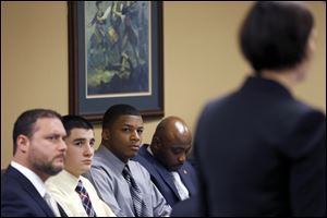 From left, Defense attorney Adam Nemann, his client, defendant Trent Mays, 17, defendant 16-year-old Ma'lik Richmond and his attorney, Walter Madison, listen to a prosecuting attorney's, right, opening statement.