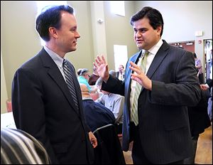 Ed FitzGerald, left, who is exploring a run for governor, talks with Toledo councilman Joe McNamara, a Toledo mayoral candidate, during  the Lucas County Democratic Party’s St. Patrick’s Day lunch at Holy Trinity Greek Orthodox Cathedral in Toledo.