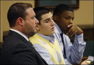 From left, Defense attorney Adam Nemann, his client, defendant Trent Mays, 17, and co-defendant 16-year-old Ma'lik Richmond listen to testimony during Mays and Richmond's trial on rape charges in juvenile court on Thursday in Steubenville.