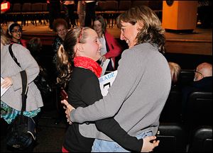 Samantha Schofield of Fallen Timbers Middle School gets a hug from her mother, Janet Schofield, after winning the Blade Northwest Ohio Championship Spelling Bee at Owens Community College.