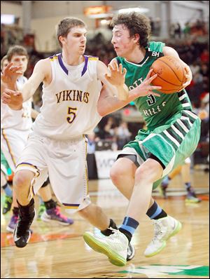 Geoff Beans, who led Ottawa Hills with 19 points, runs into the defense of Leipsic's Derek Steffan in a Division IV regional final at BGSU.