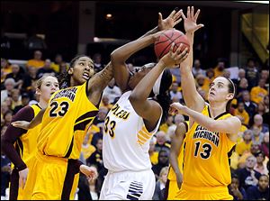 Toledo's Yolanda Richardson is sandwiched by Central Michigan's Crystal Bradford, left, and Jessica Schroll during second half of a MAC semifinal at Quicken Loans Arena in Cleveland.