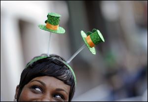 Krystal Thomas of Atlanta parties on River Street while wearing a shamrock head-band during the 189th St. Patrick's Day celebration in Savannah, Ga.