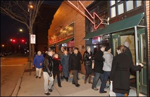 Ticket holders enter Ye Olde Cock N' Bull Tavern to sample its food during the Dishcrawl in downtown Toledo.