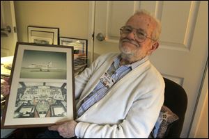 Ken Colthorpe, 91, with photos of the exterior and interior of a Champion company Gulfstream, circa 1980.