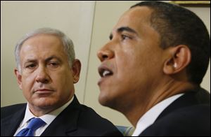 Israeli Prime Minister Benjamin Netanyahu, right, looks towards President Barack Obama as he speaks to reporters in the Oval Office of the White House in Washington.