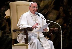 Pope Francis smiles during a meeting with the media at the Pope Paul VI Audience Hall in the Vatican on Saturday.