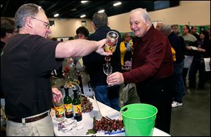 It’s Your Winery’s Dave Foltz pours Toledoan Bill McDaniel a sample during the Glass City Wine Festival at the SeaGate Convention Centre in Toledo. Festival attendees gave the event high marks.