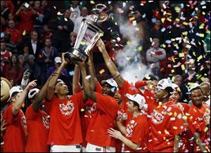 Ohio State players celebrate after winning an NCAA college basketball game against Wisconsin in the championship of the Big Ten tournament. Ohio State won 50-43.