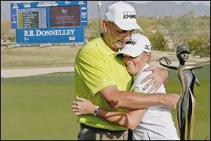 Stacy Lewis, a Toledo native, gets a hug from her father, Dale Lewis, after winning the LPGA Founders Cup. Dale is a Whitmer graduate.