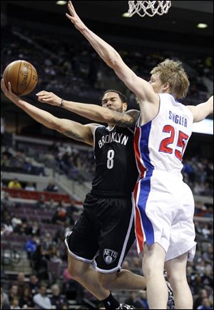 Brooklyn Nets guard Deron Williams (8) goes to the basket against Detroit Pistons forward Kyle Singler (25).
