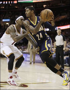 Indiana Pacers' Paul George (24) drives past Cleveland Cavaliers' Daniel Gibson (1) during the third quarter of an NBA basketball game. The Pacers won 111-90.