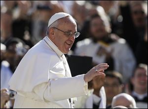 Pope Francis waves to crowds as he arrives at his inauguration Mass in St. Peter's Square at the Vatican.