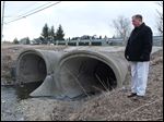  Sylvania's service director Kevin Aller stands besides the bridge on Erie Street, west of Erie Farms Court, to be repaired.