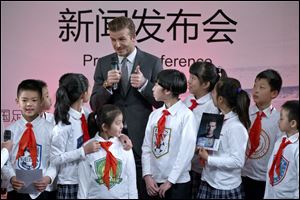 David Beckham speaks during a promotional event at Shijia Primary School in Beijing.