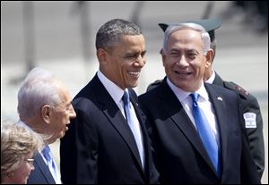 President Obama, center, Israel's prime minister Benjamin Netanyahu, right, and Israeli President Shimon Peres, second left, laugh as they walk during a welcoming ceremony upon Obama's arrival at Ben Gurion airport near Tel Aviv, Israel.